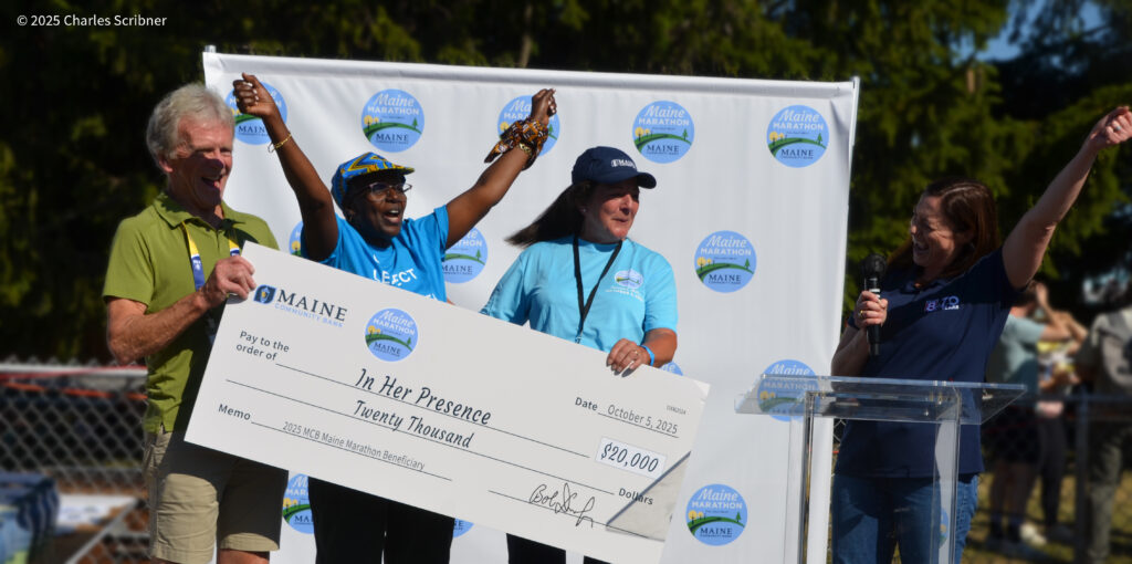 In her presence receiving check from Maine Marathon
