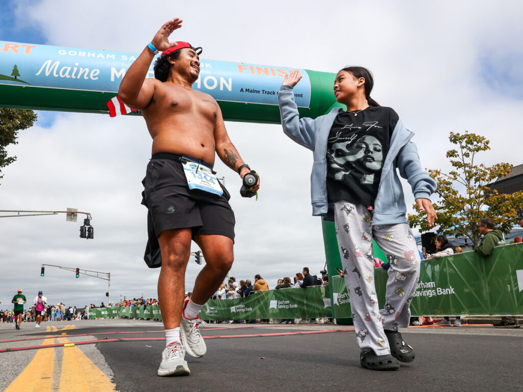 Finisher high fives at finish line