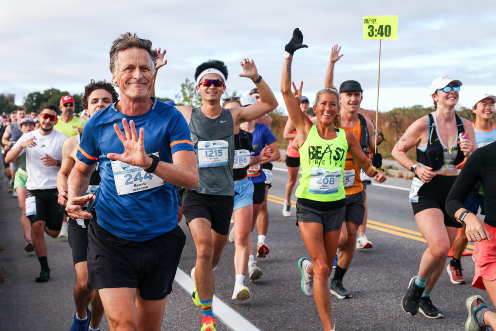 Runners on course waving to camera