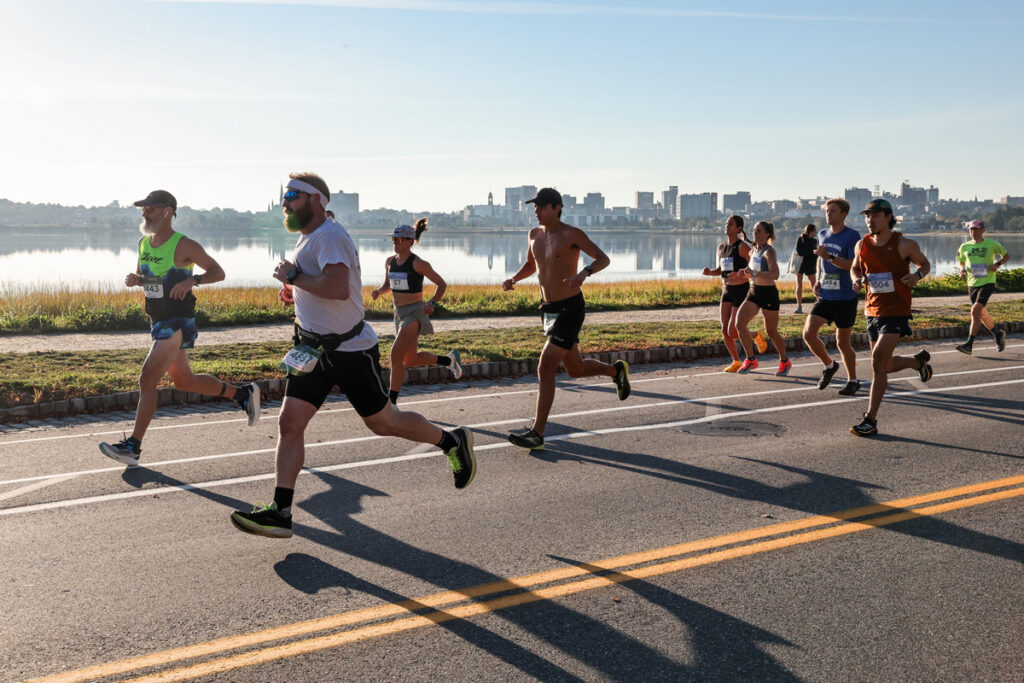 skyline behind runners